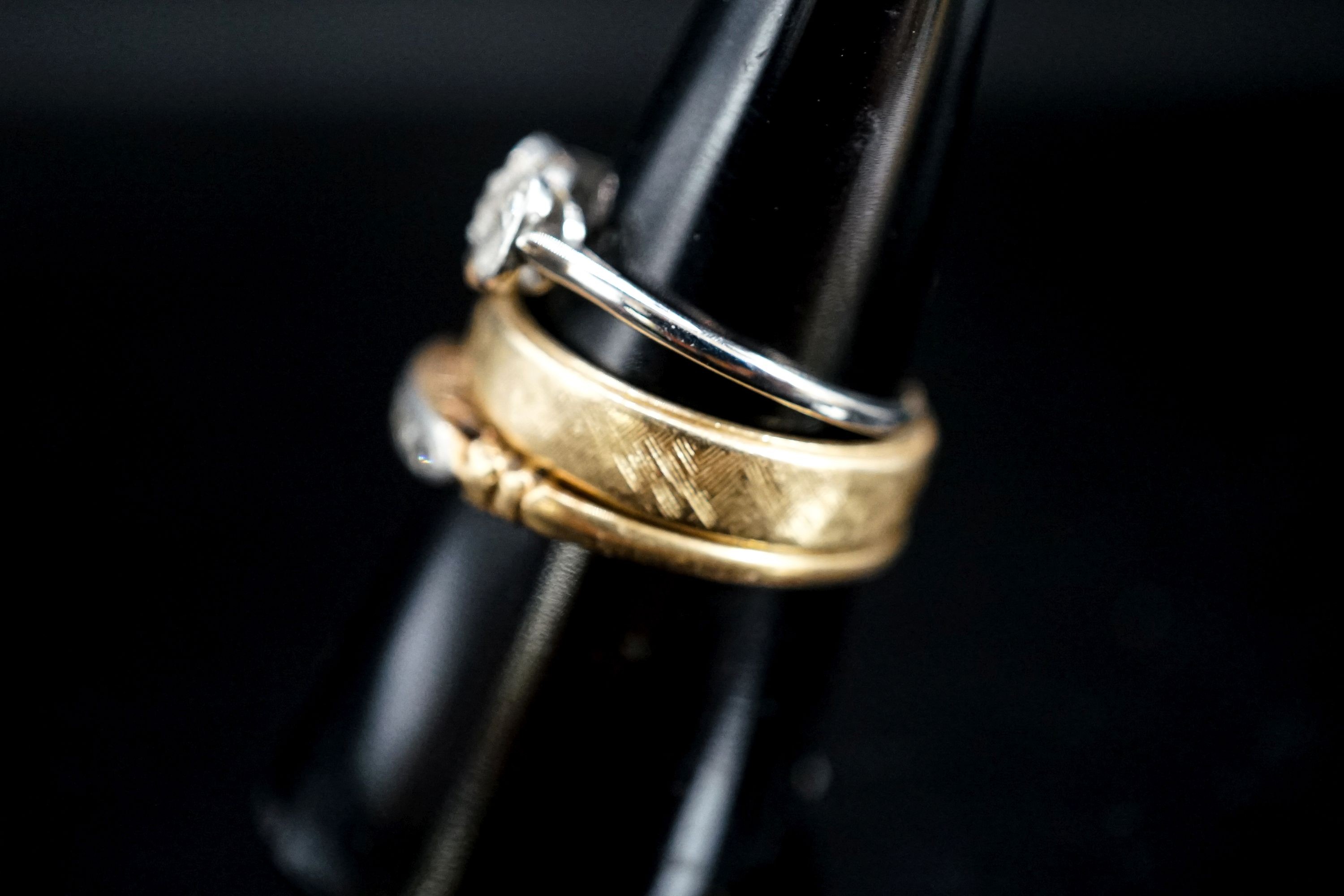 A 14k yellow metal band and two other diamond set rings, one stamped 14k, gross weight 7.5 grams.